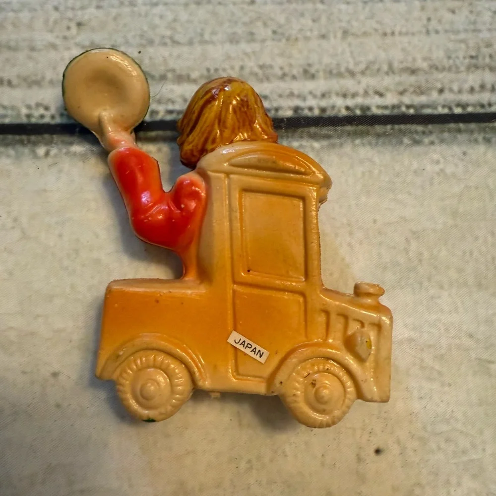 Vintage clown figurine riding in a car. Made in Japan.
